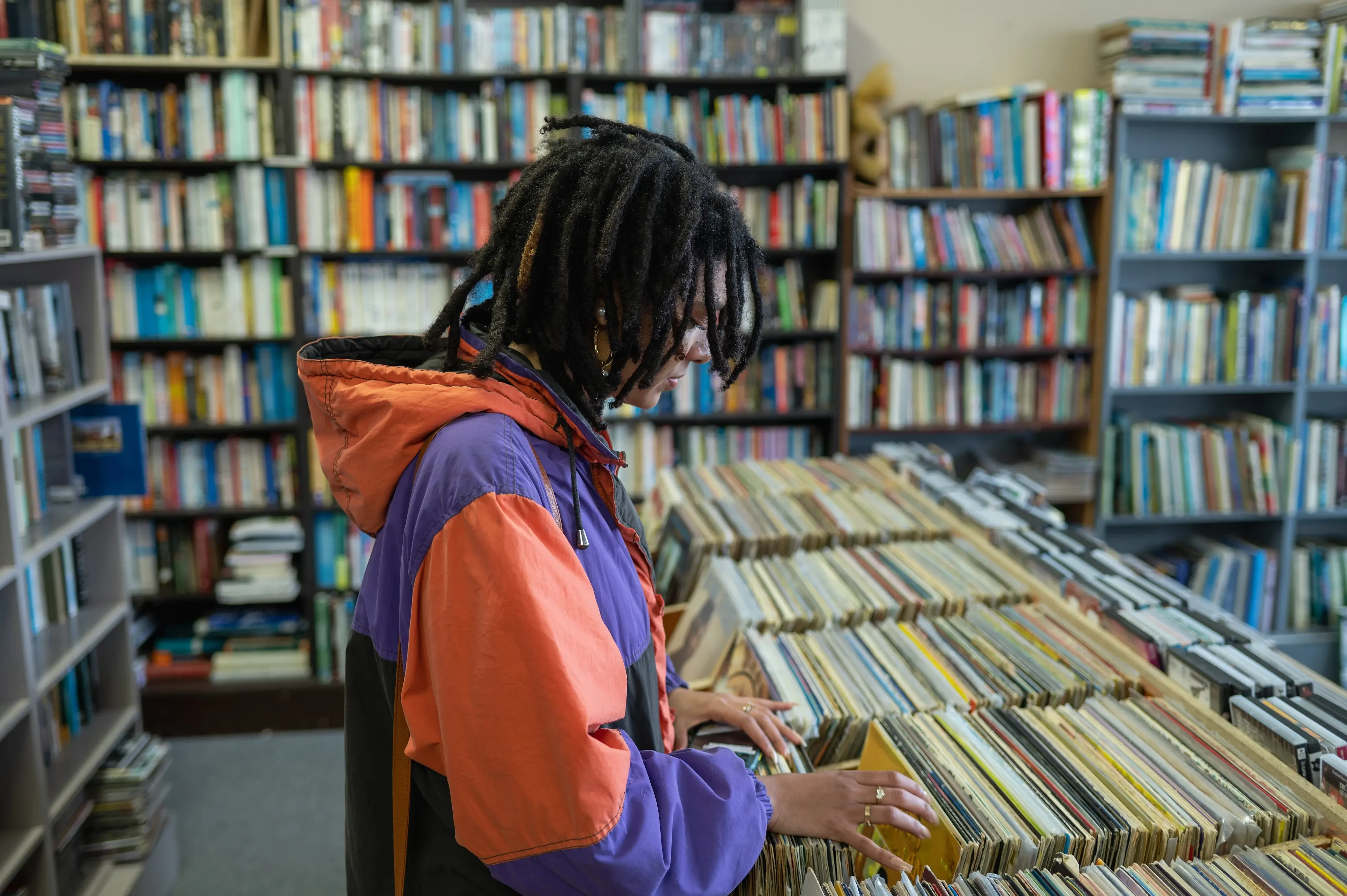 woman sorting through vinyl records at a record store