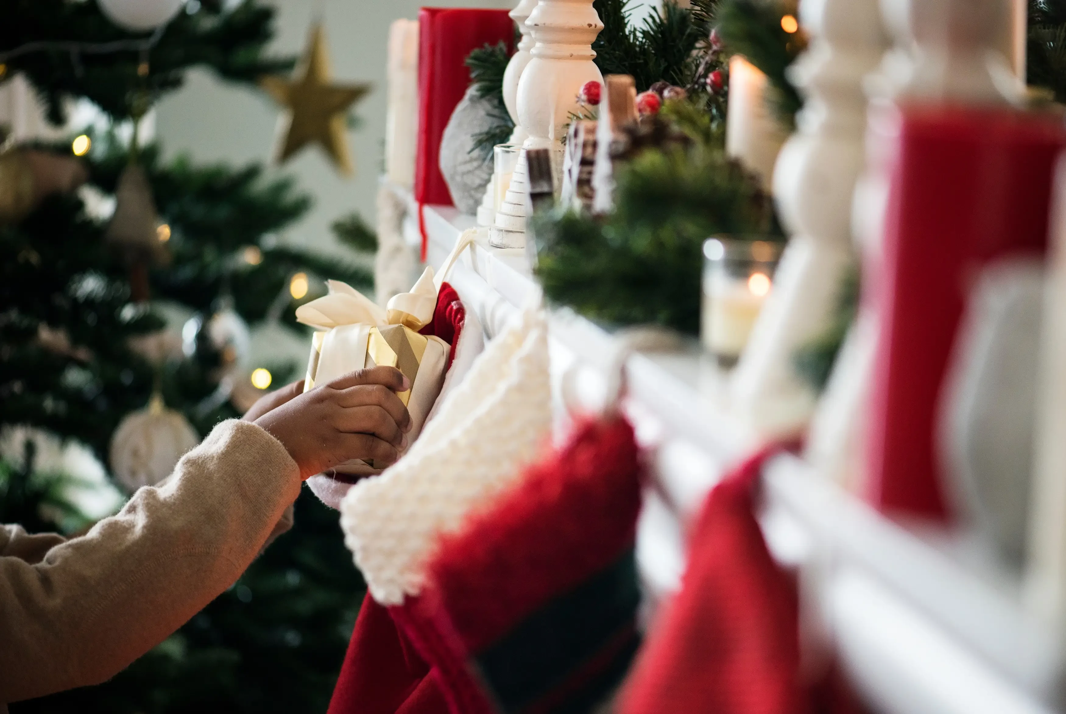woman stuffing stocking with gifts