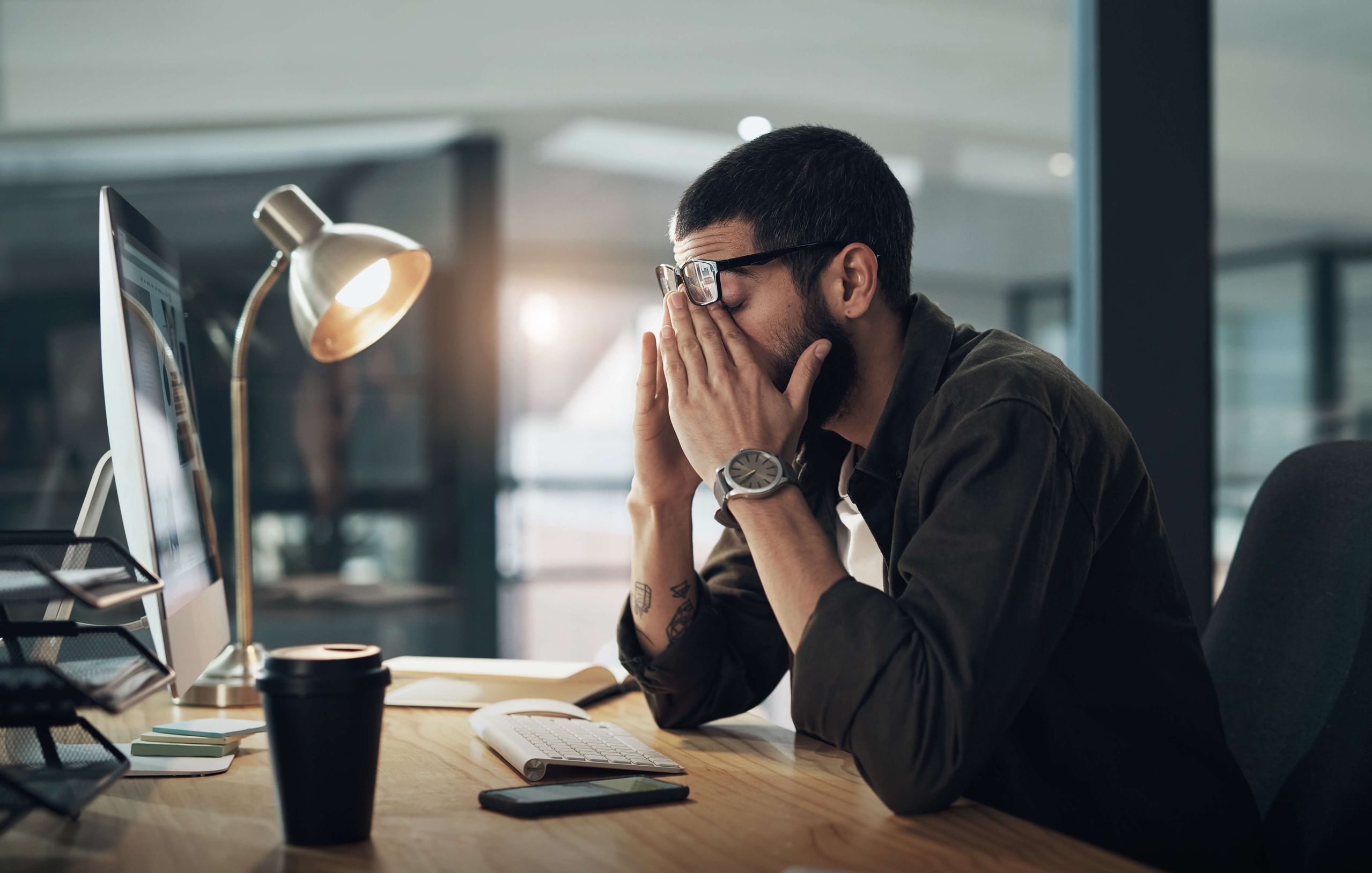 man swamped at work, stressed out