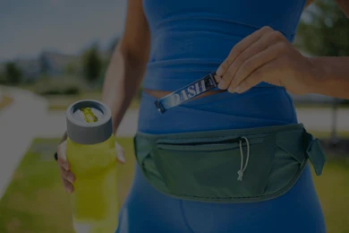 woman pulling a packet of thc powder from her fanny pack