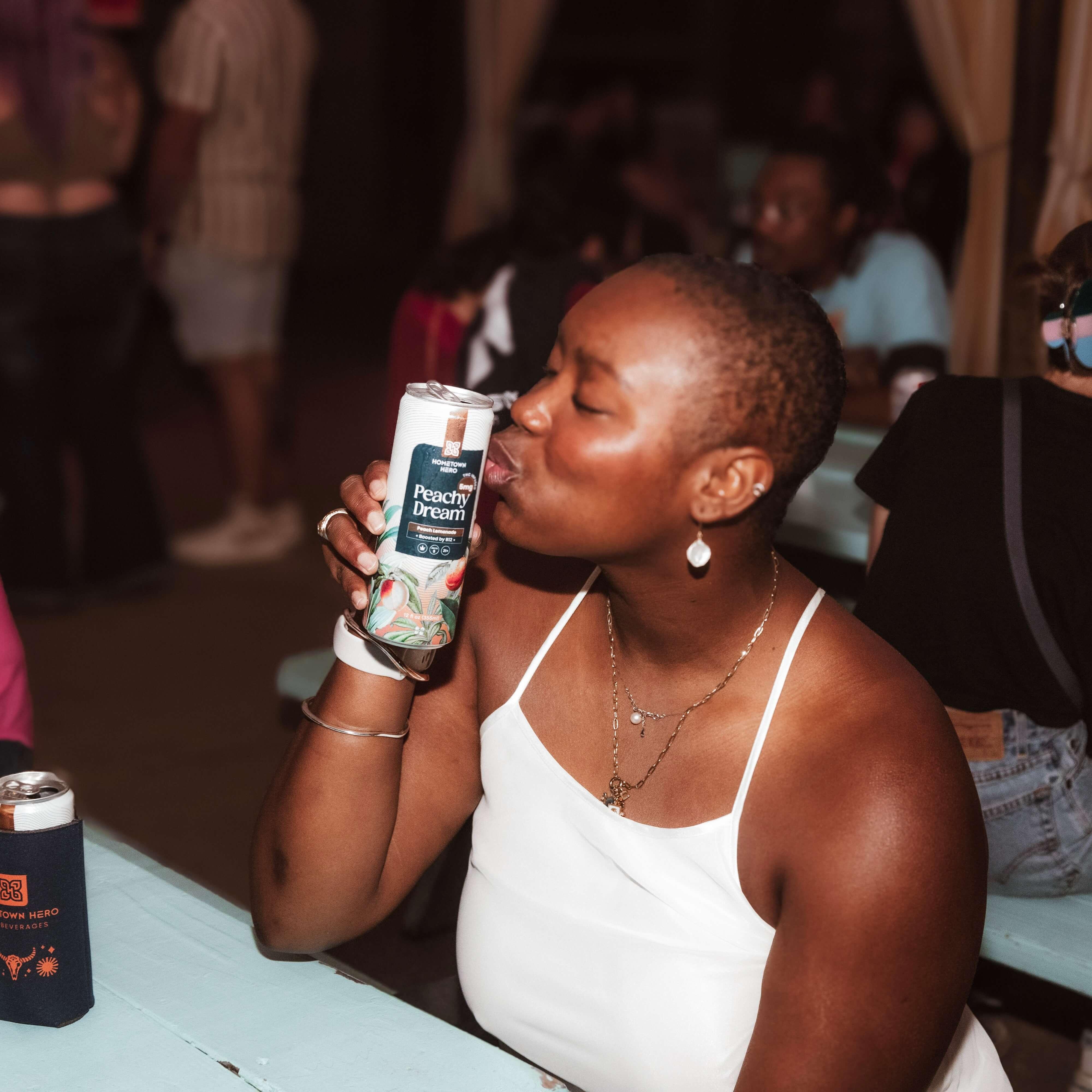 woman kissing can of THC lemonade
