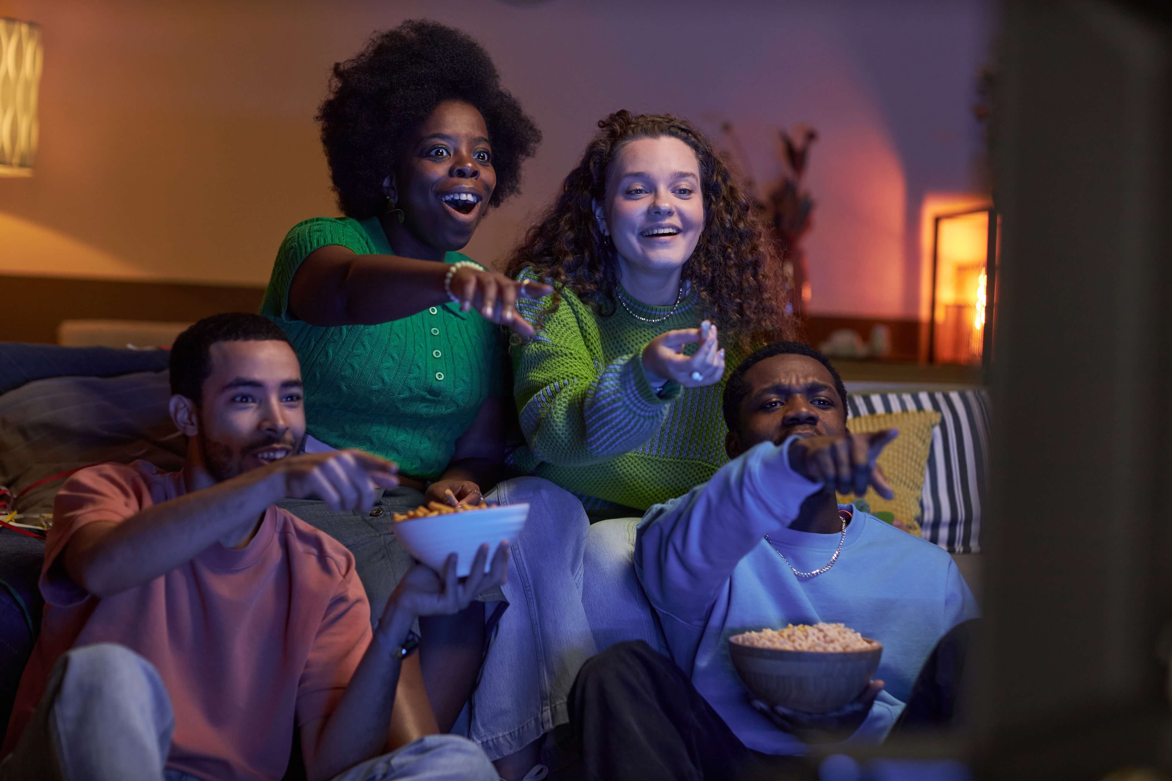 pointing at tv laughing