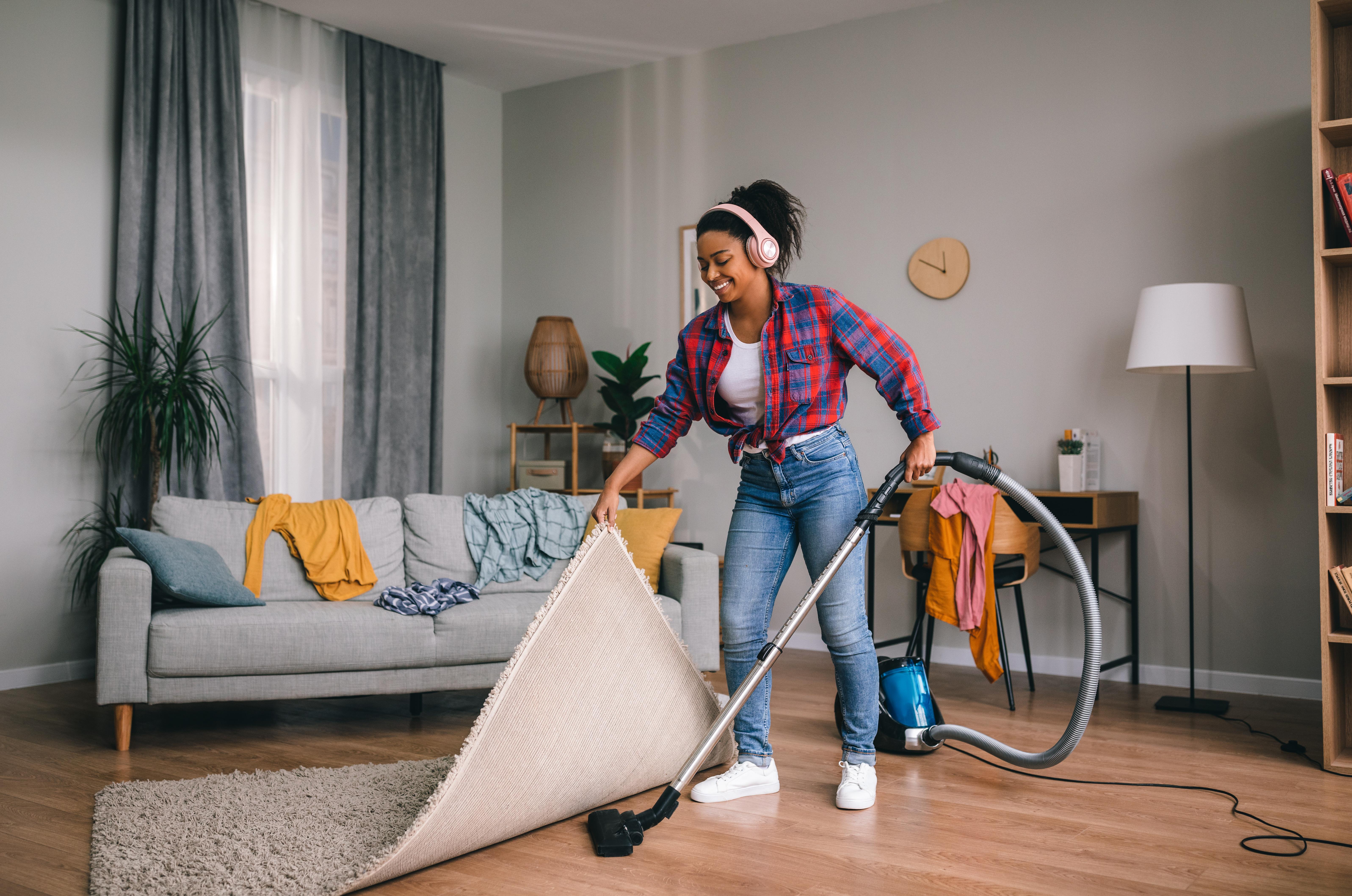 Woman vacuuming happily.