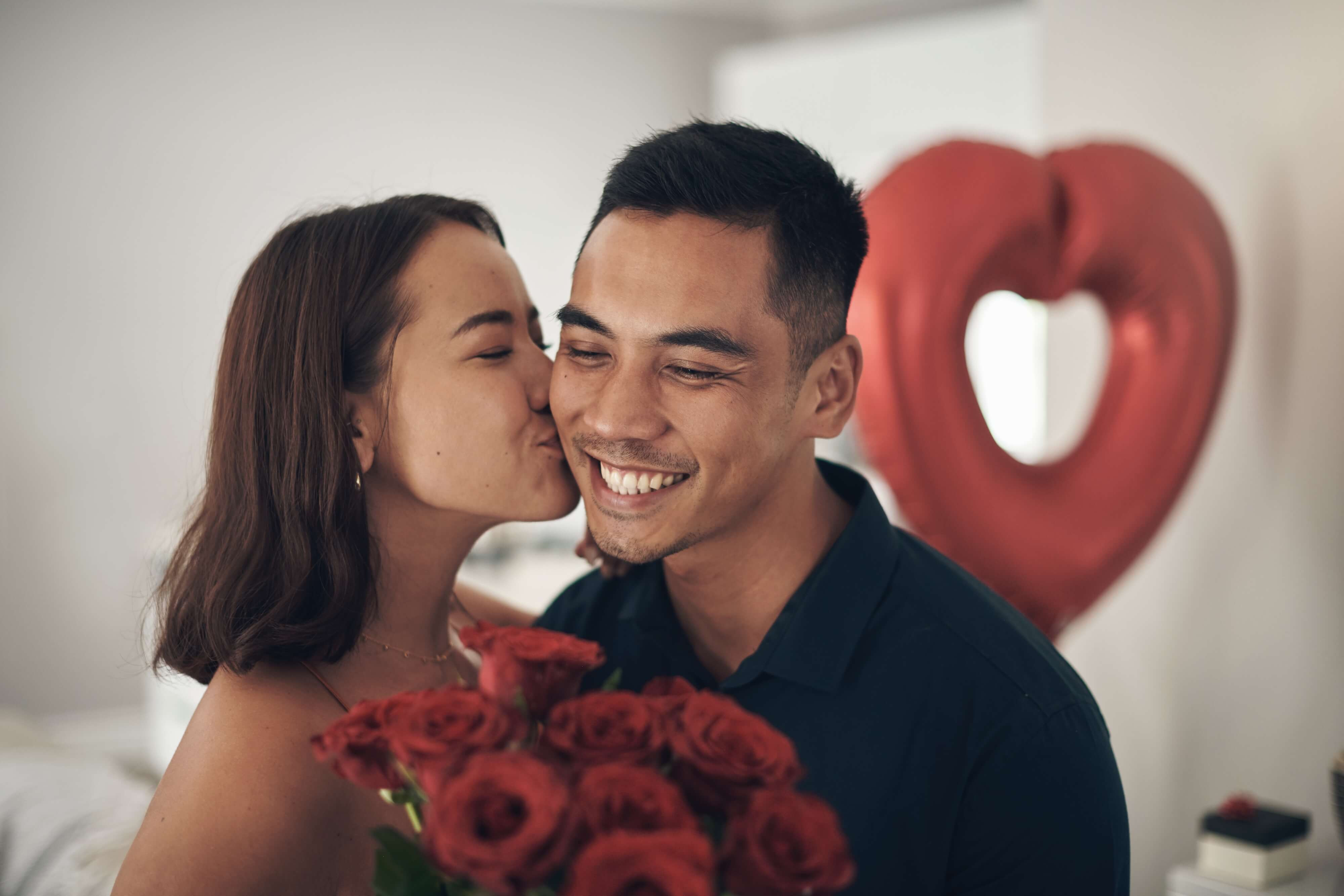 couple smiling as they share valentines gifts