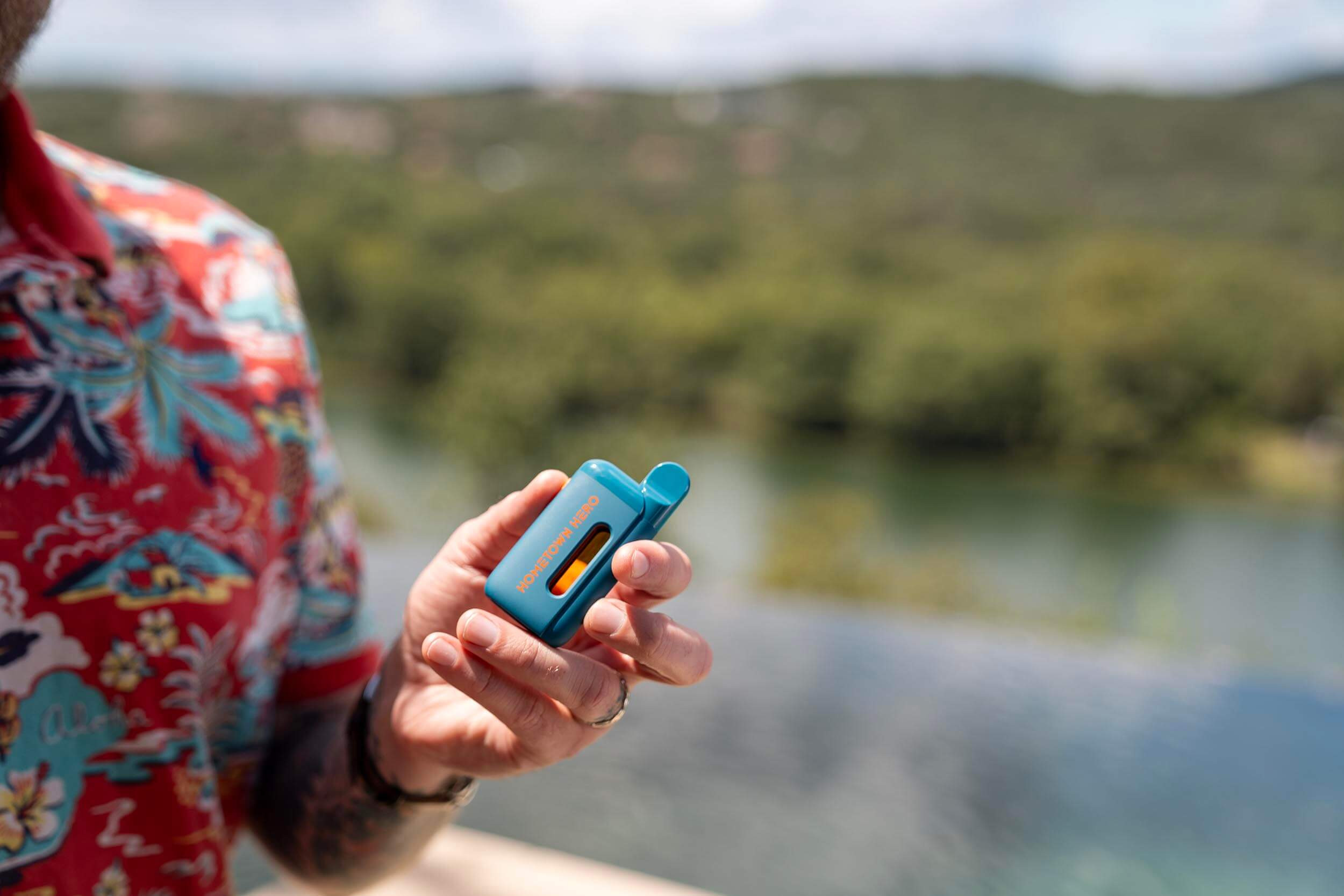 man holding a 5g disposable vape device